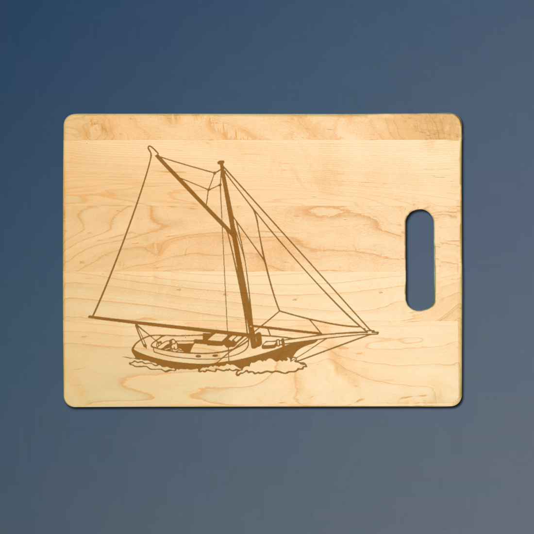 Personalized maple sailboat cutting board with custom engraved sailboat design.