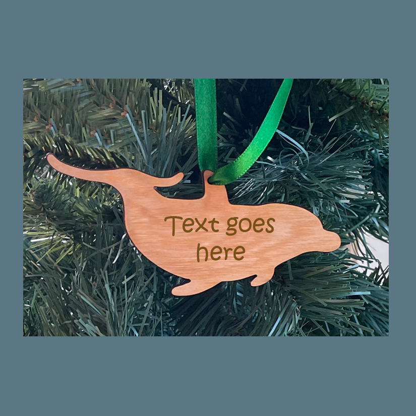 Wood dolphin Christmas ornament with your choice of wood type, size and personalized text. Dolphin Ornament