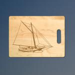 Personalized maple sailboat cutting board with custom engraved sailboat design.